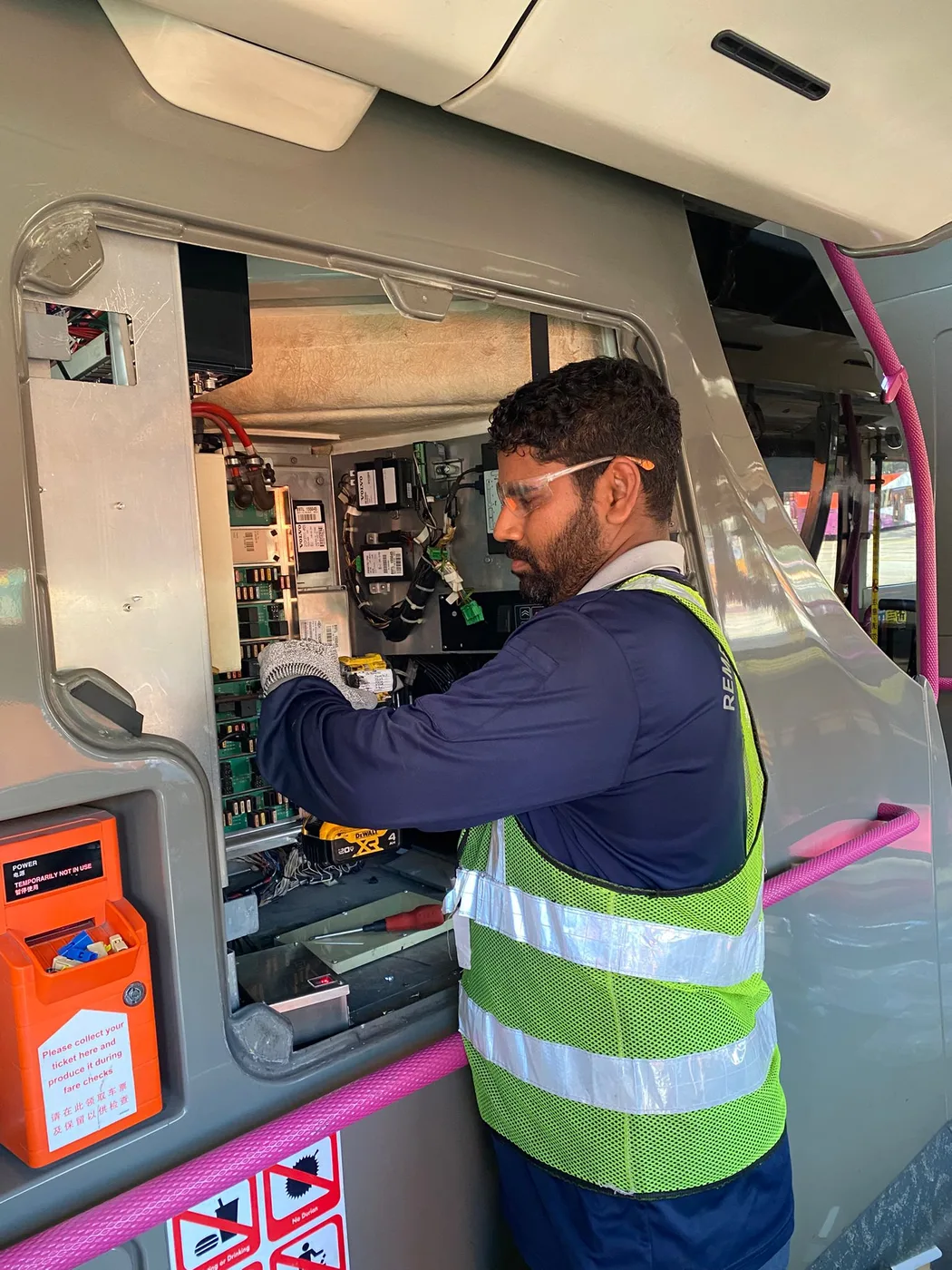 CCST technician servicing in-vehicle electronics and a control panel