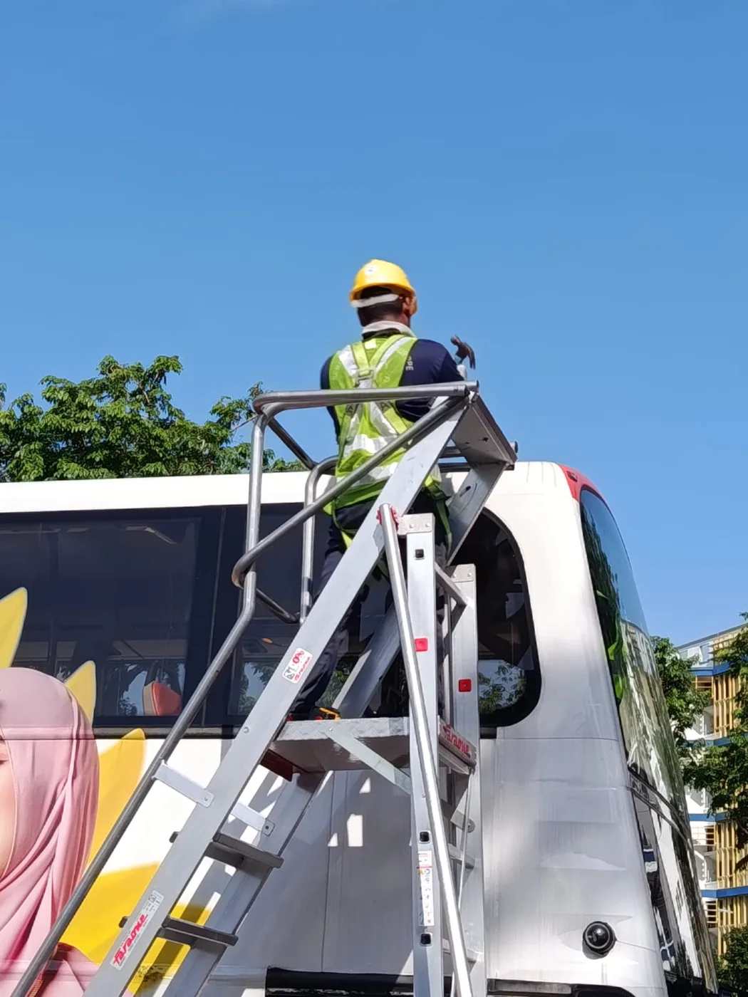 CCST technician on a raised platform installing roof-mounted equipment on a vehicle